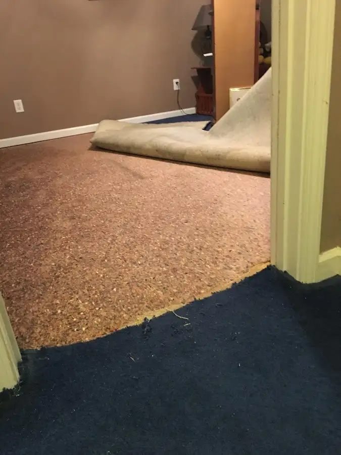 Carpet pad removal revealing water damage during Drying & Dehumidification in Garrett